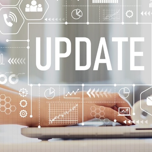 Person typing on a laptop computer with the words "Update" in the background.