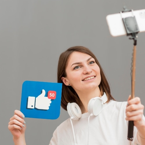 portrait-smiley-woman-recording-herself-for-digital-creation-on-facebook
