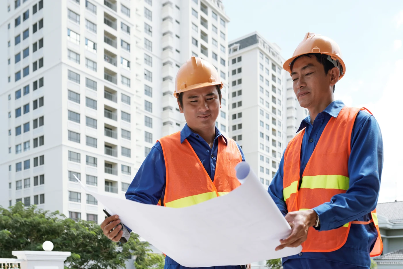 Construction engineers reviewing plans on a building site