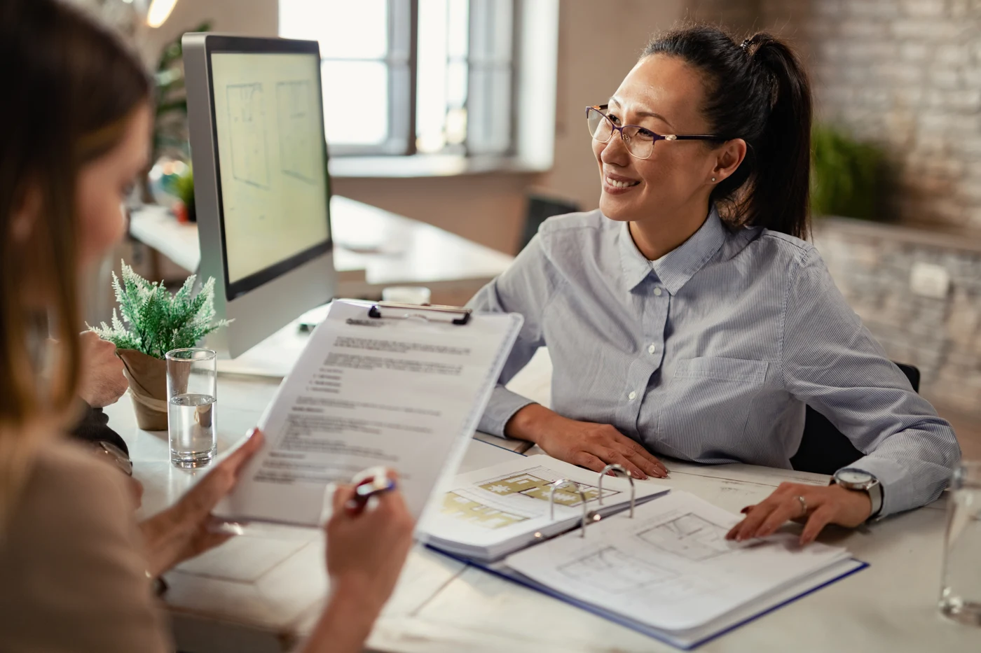 Financial services adviser discussing documents with a client