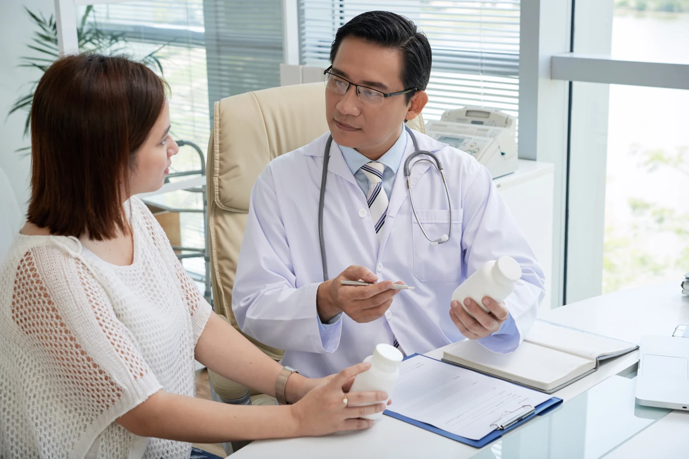 Doctor discussing care with a patient in a bright consultation room