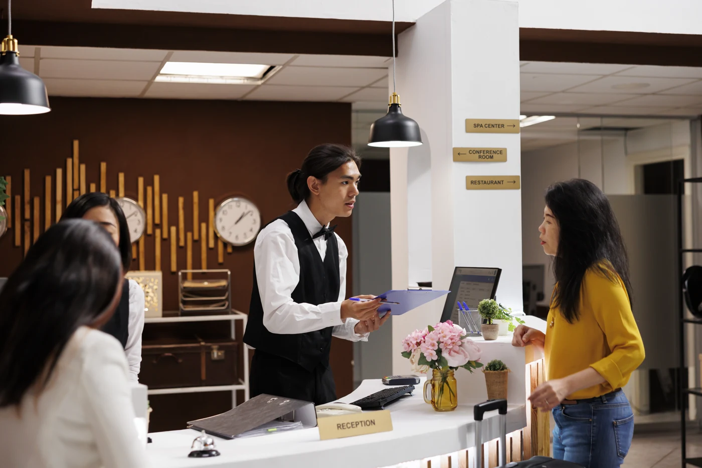 Hotel team welcoming guests at reception