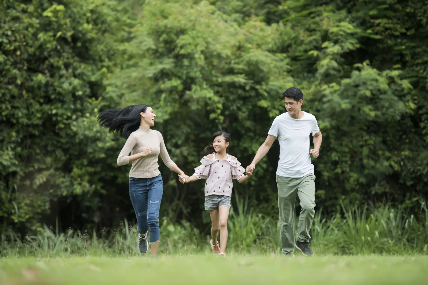 Parents and their child enjoying time together in a park