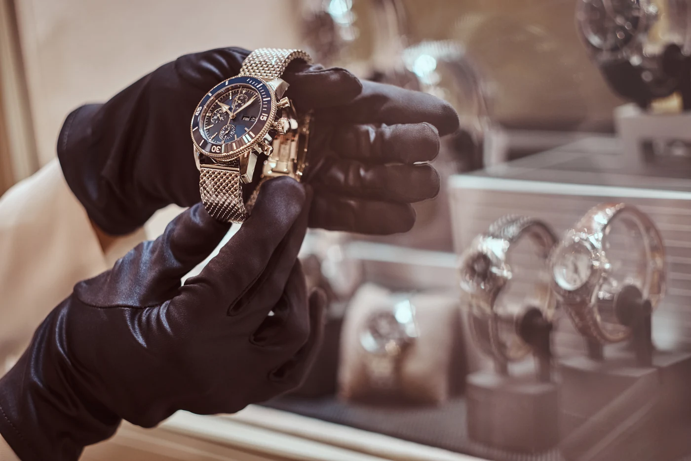 Specialist presenting a wristwatch in a luxury retail store