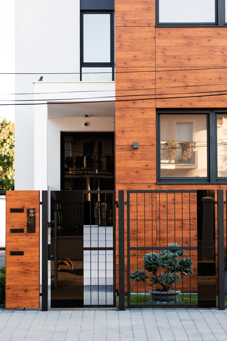 Entrance of a modern residential building with timber and white exterior