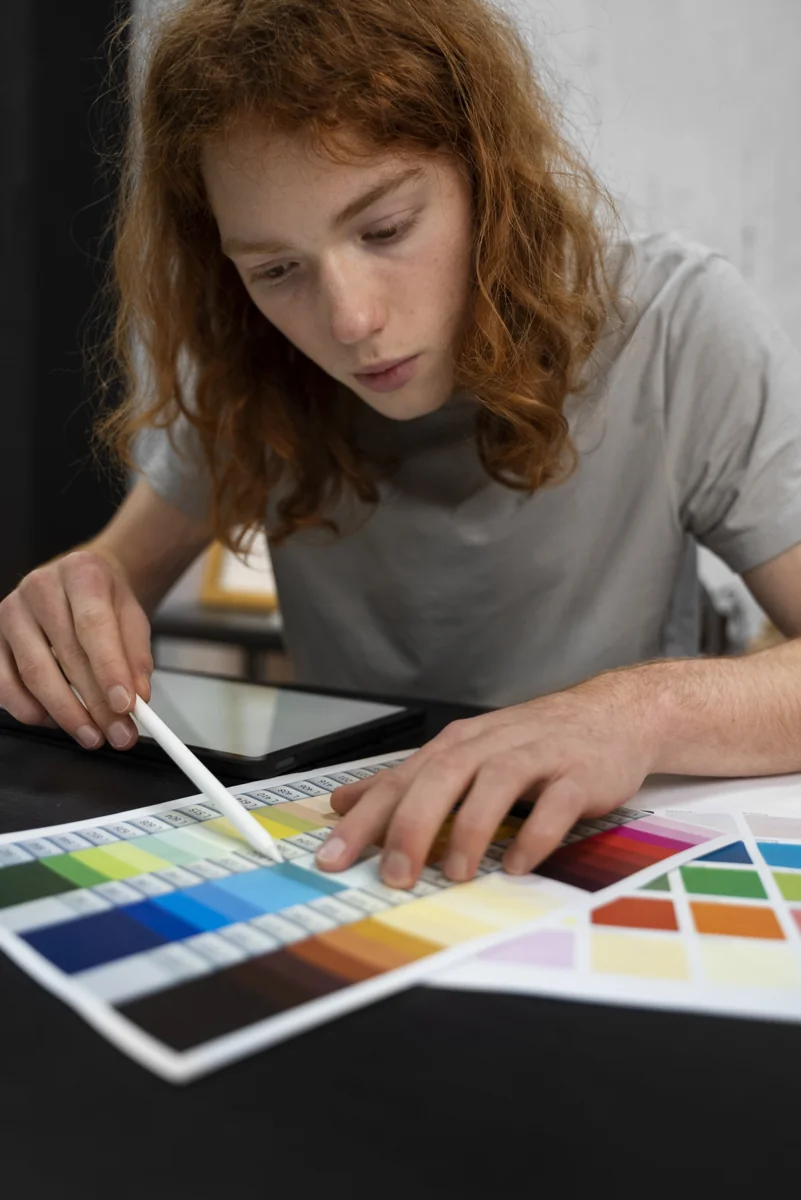 Designer working with a drawing tablet and colour palettes